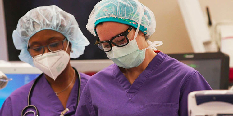 photo of two postdoctoral residents in an operating room