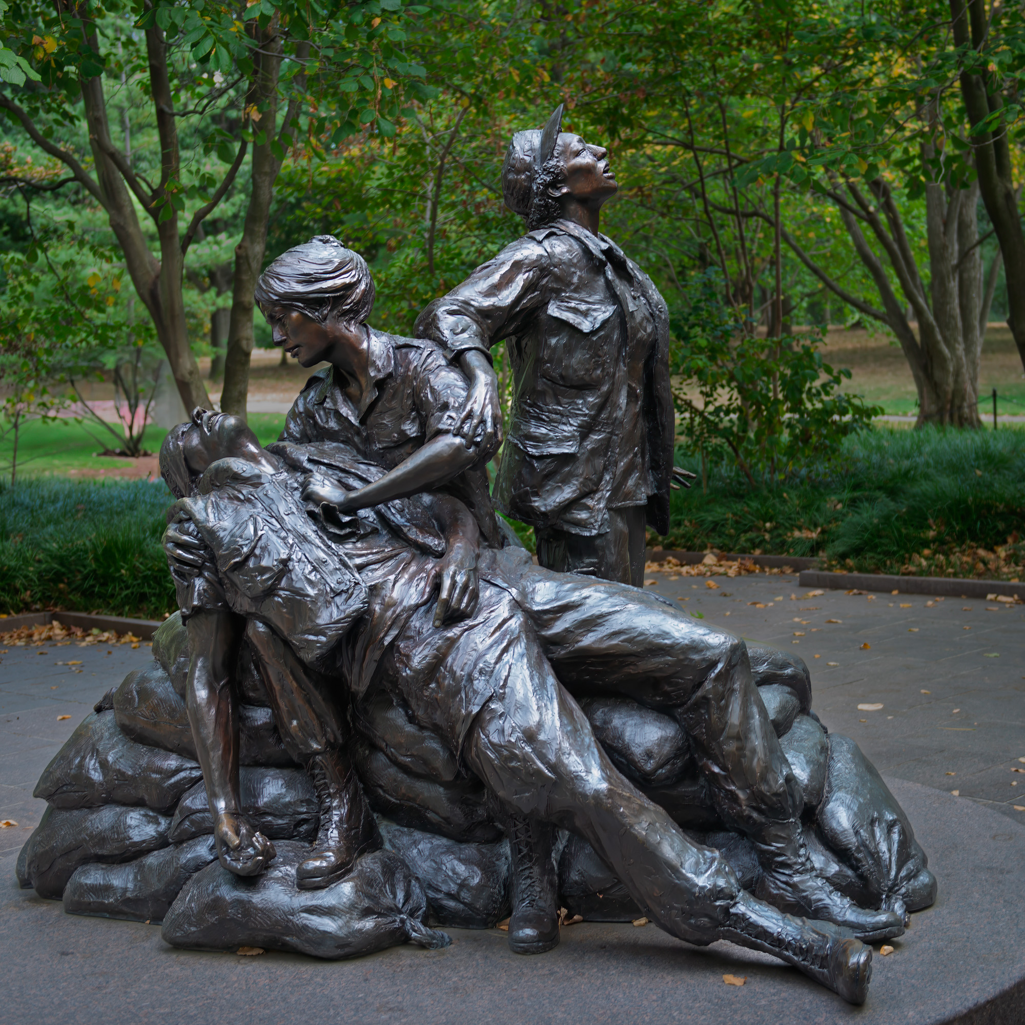 Photograph of the Vietnam Women's Memorial in Washington, D.C. which features a bronze sculpture depicting three women caring for a wounded soldier.
