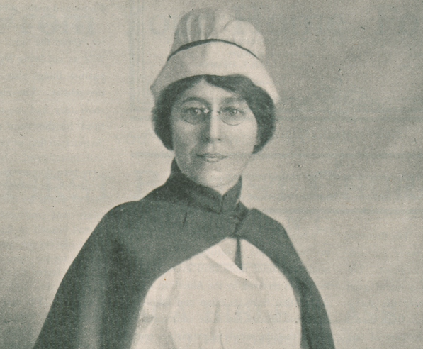 Nurse Standish. Black and white image, with her in front of a wall, wearing nurse cap and cape.
