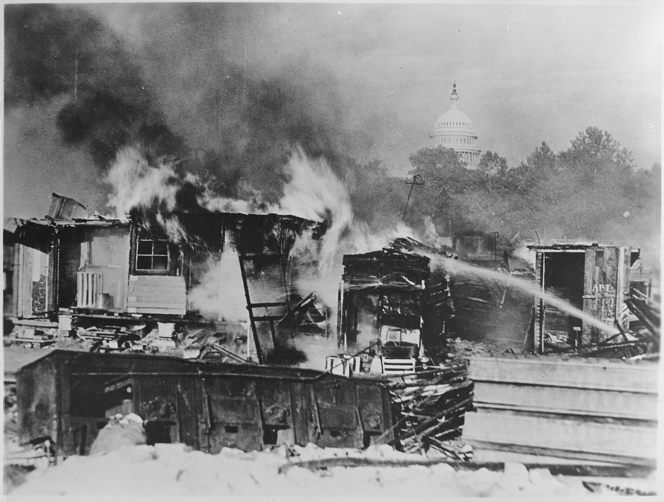 Bonus Army camps went up in flames after the U.S. Army evicted protesters on the night of July 28, 1932. The dome of the Capitol Building is visible in the distance. (National Archives)