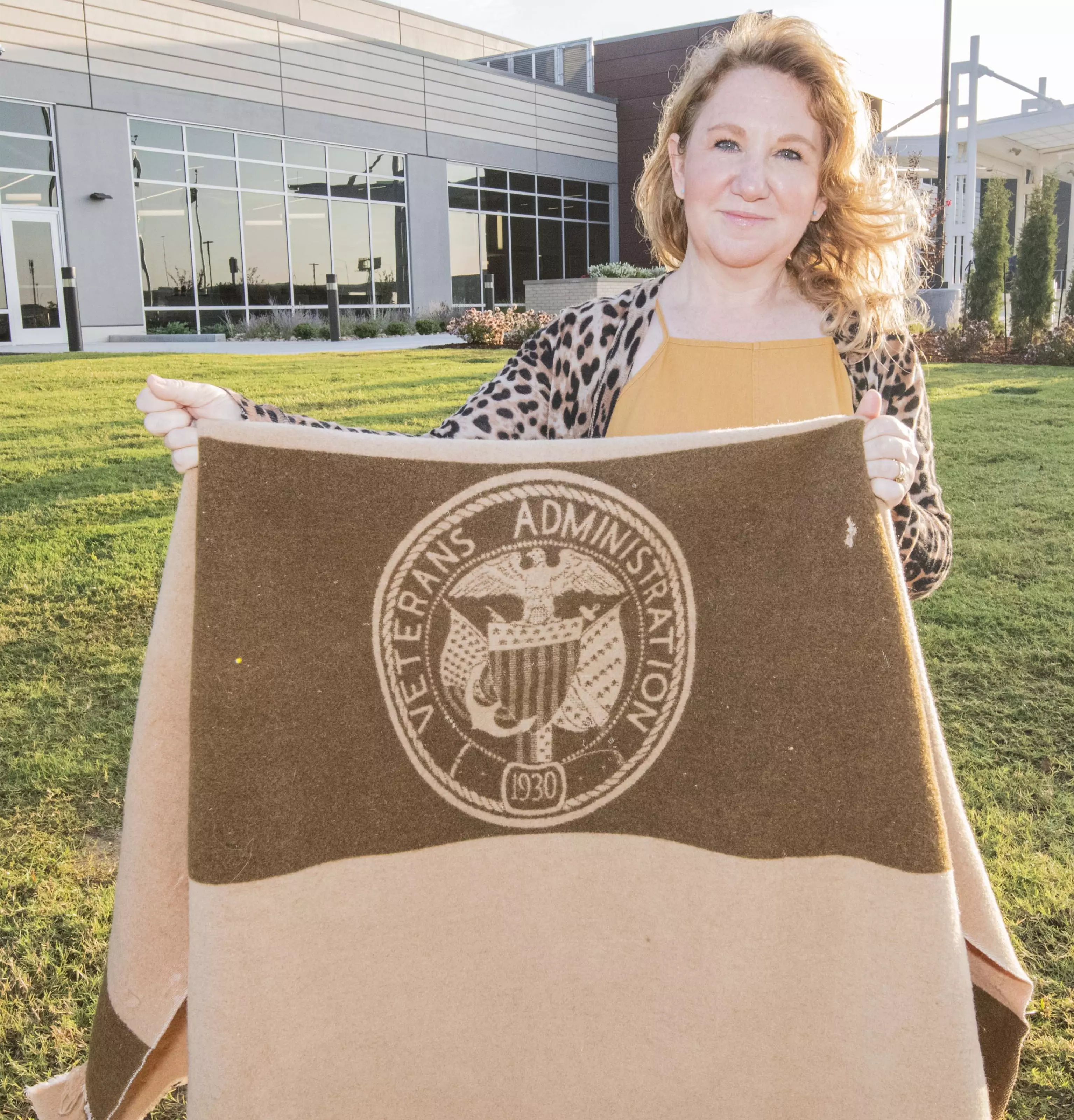 VA Psychologist Arena Mueller holds a 1930 Veterans Administration blanket she donated to the National VA History Center. Photo taken at the Ernest Childers VA Outpatient Clinic in Tulsa, Oklahoma. (VA Photo)