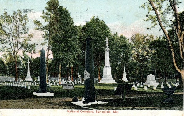 Postcard of Springfield National Cemetery, Missouri, c. 1908, showing the bronze shield on the inverted cannon in the foreground. (NCA)
