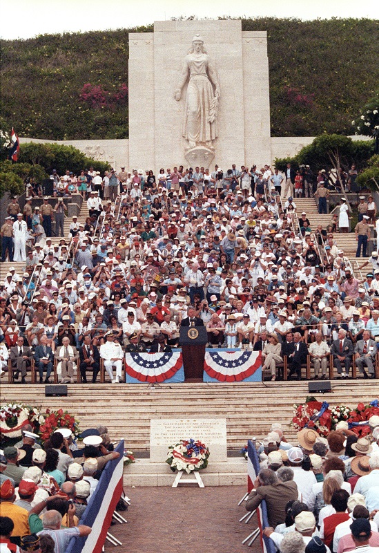 President Bill Clinton speaking at a ceremony commemorating the fiftieth anniversary of V-J Day and the end of World War II at the National Memorial Cemetery of the Pacific in Hawaii in 1995. Hundreds of WWII Veterans attended, many wearing their medals. (Clinton Presidential Library)