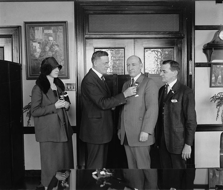 Frank Hines receiving a ceremonial poppy flower in 1925. Artificial poppies became a popular form of remembrance after World War I. (Library of Congress)