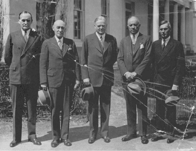 Group photo of signatories for Executive Order 5398, which consolidated three agencies into the Veterans Administration. Left to right: Col. George E. Ijam, acting Veterans Bureau Administrator, later VA Assistant Administrator; Brig. Gen. Frank T. Hines, Administrator of Veterans Affairs; President Herbert Hoover; Col. Louis H. Tripp, Director of Construction; Charles M. Griffith, M.D., Chief Medical Director. (Charles M. Griffith, Jr)