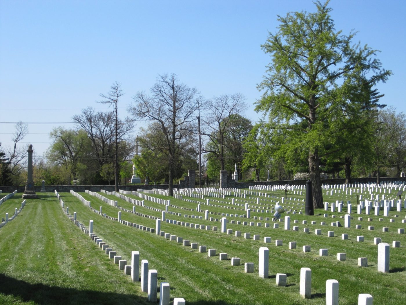 Photo of Winchester National Cemetery, Virginia, July 2011, showing rows of 6x6 markers interspersed with upright headstones. (NCA)