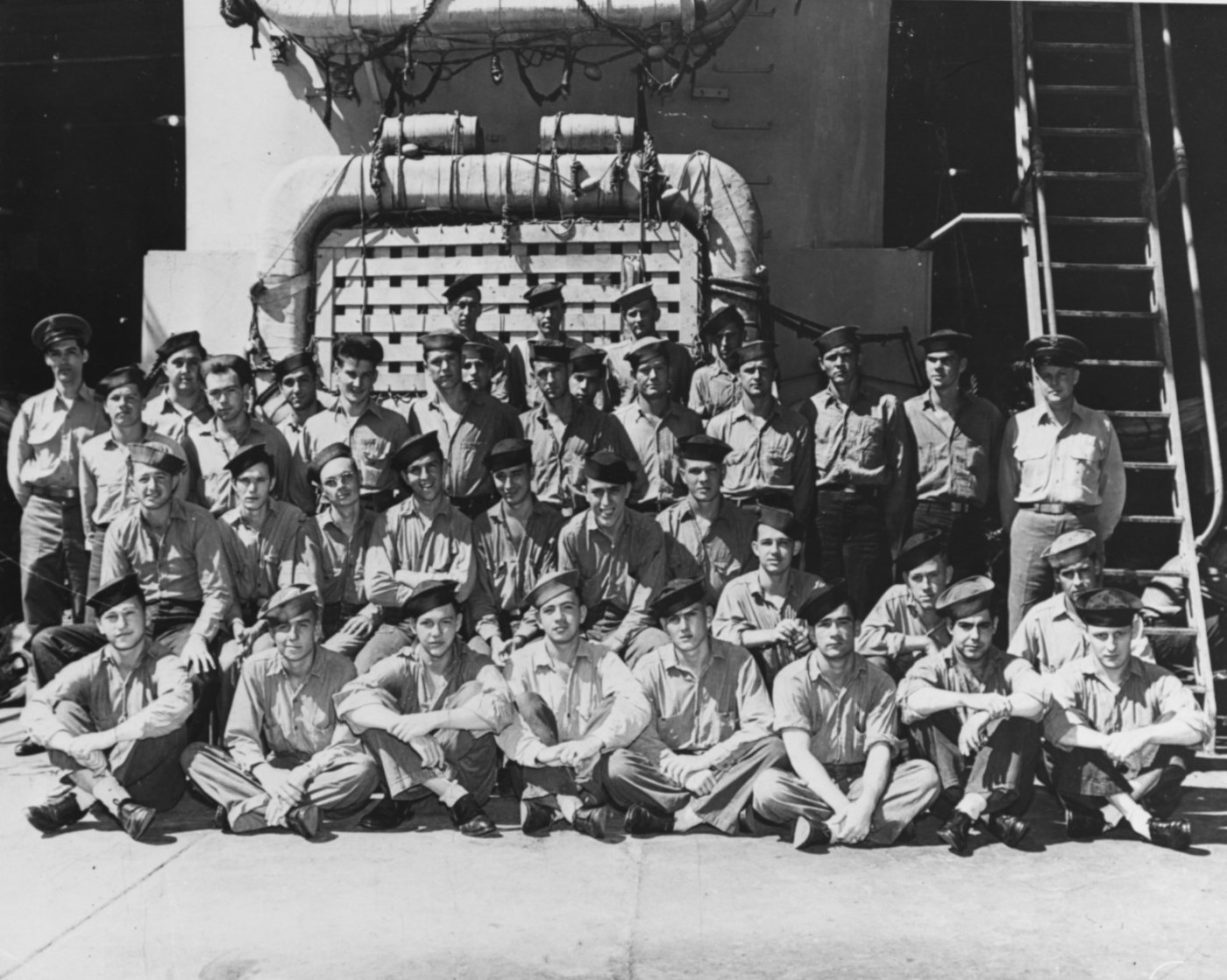 Members of the ship’s crew pose in the well deck, during World War II. Photograph was taken prior to her final overhaul, completed in July 1945. (National Archives)