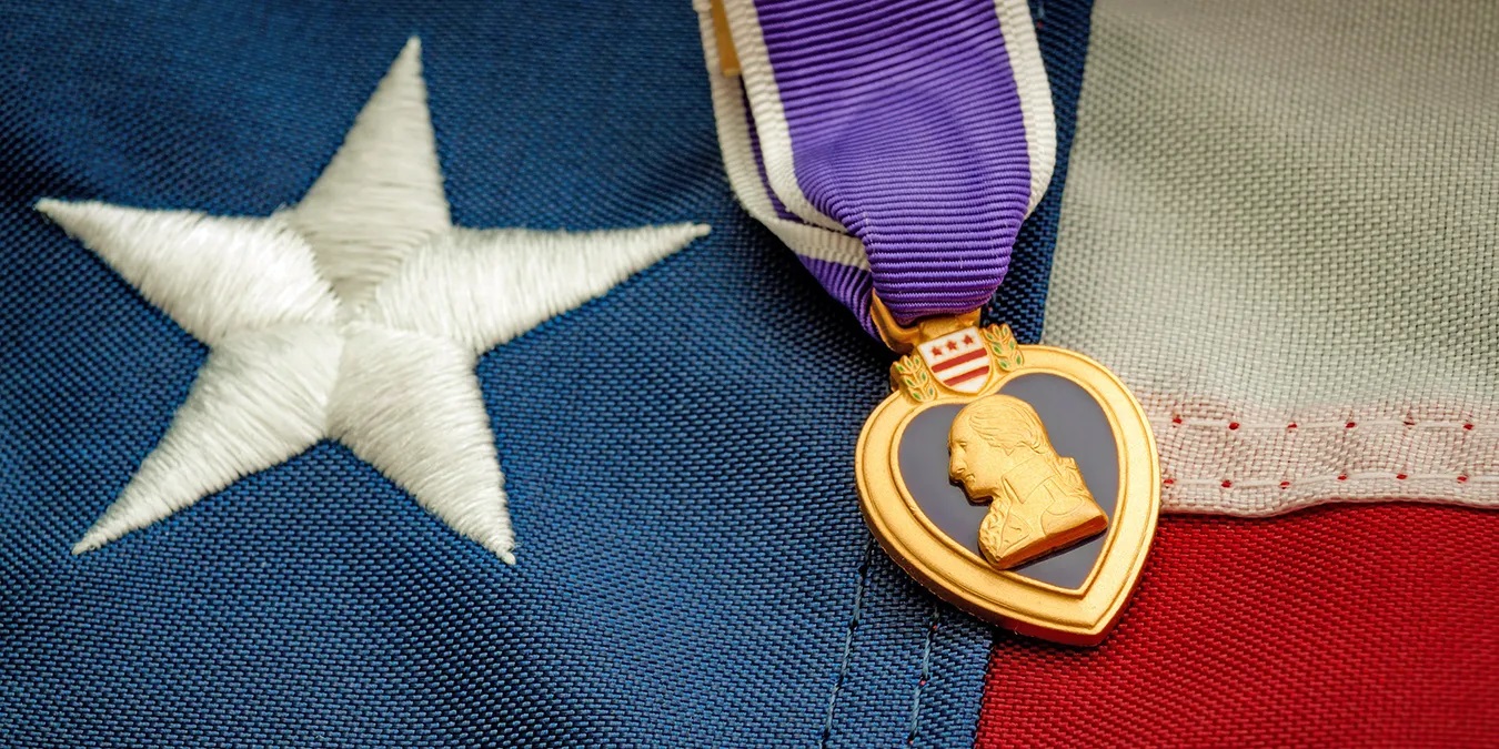 The Purple Heart medal lying on the American flag.