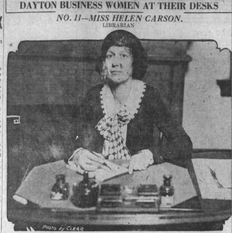 Photograph of Helen Carson at her desk from a Dayton Daily News article about prominent businesswomen in Dayton.