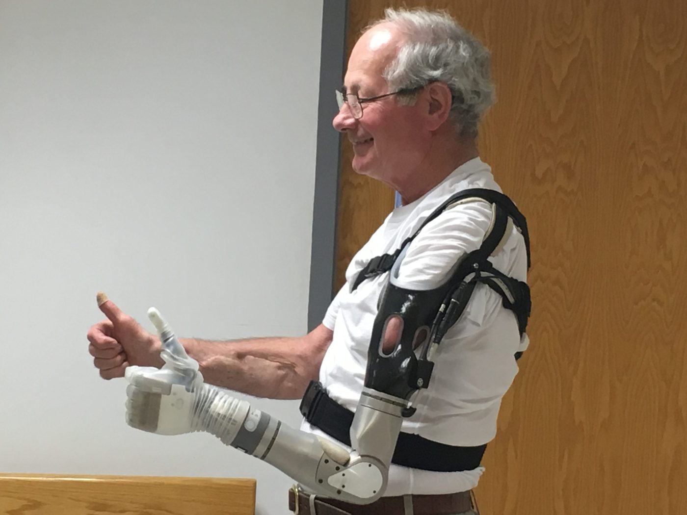 Much decorated Vietnam Veteran and former VA executive Frederick Downs, Jr., gives a thumbs up while demonstrating the fluid movements possible with the LUKE arm. At an event hosted by VA in 2017, Downs and another Veteran became the first recipients of the artificial arm. (darpa.mil)
