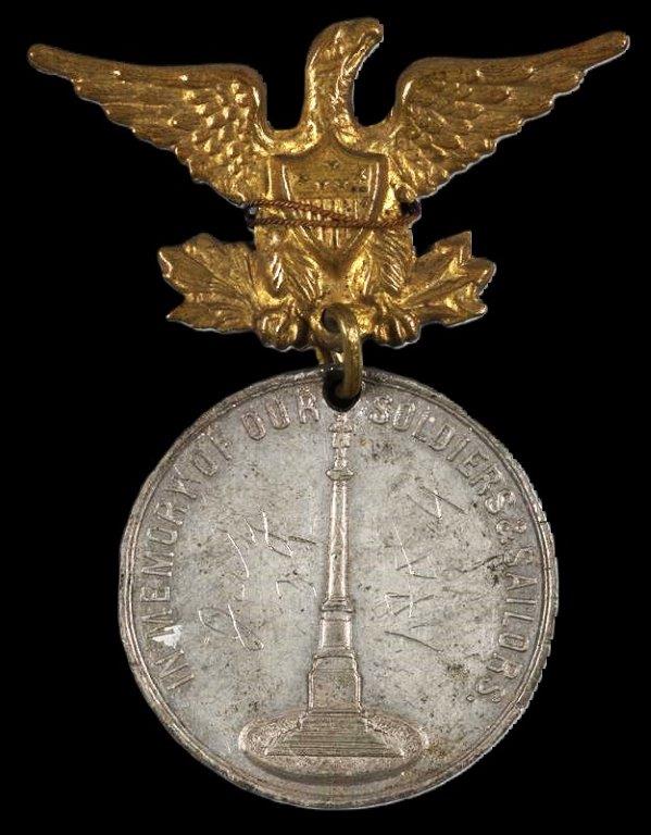 Commemorative medal with eagle hanger. The obverse of the medal depicts the column of the soldiers monument, the reverse of the medal reads “Unveiled Dayton Ohio, July 31, 1884”. (VA)