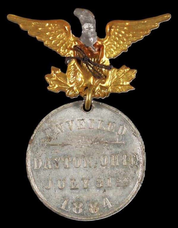 Commemorative medal with eagle hanger. The obverse of the medal depicts the column of the soldiers monument, the reverse of the medal reads “Unveiled Dayton Ohio, July 31, 1884”. (VA)