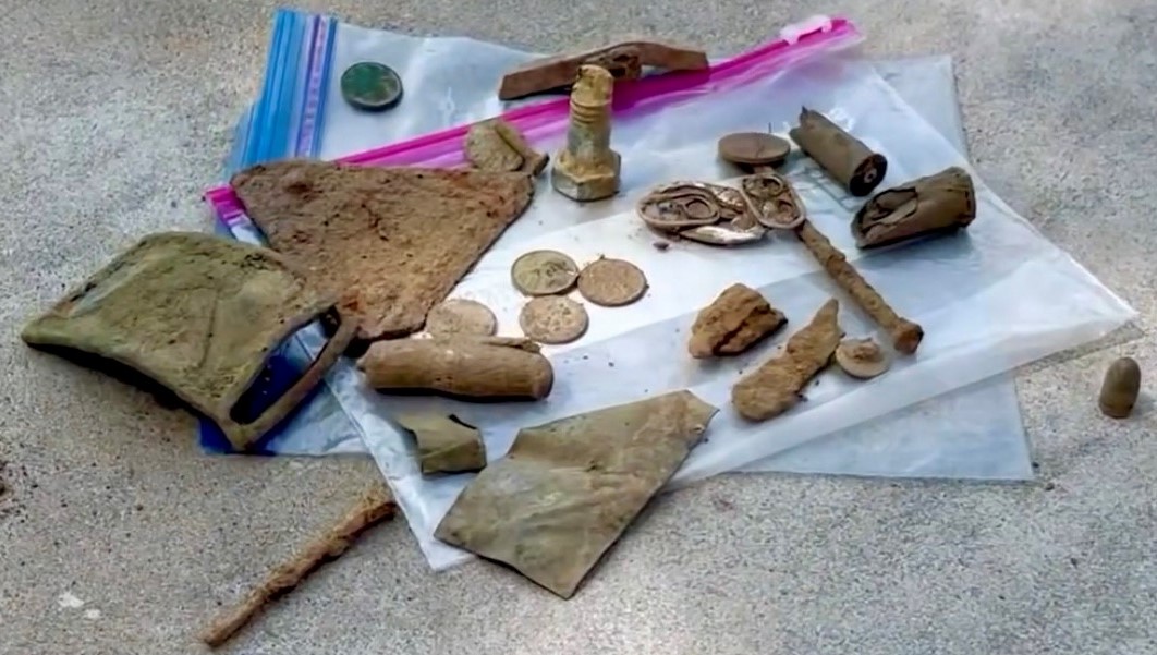 Items found by the diggers include coins.