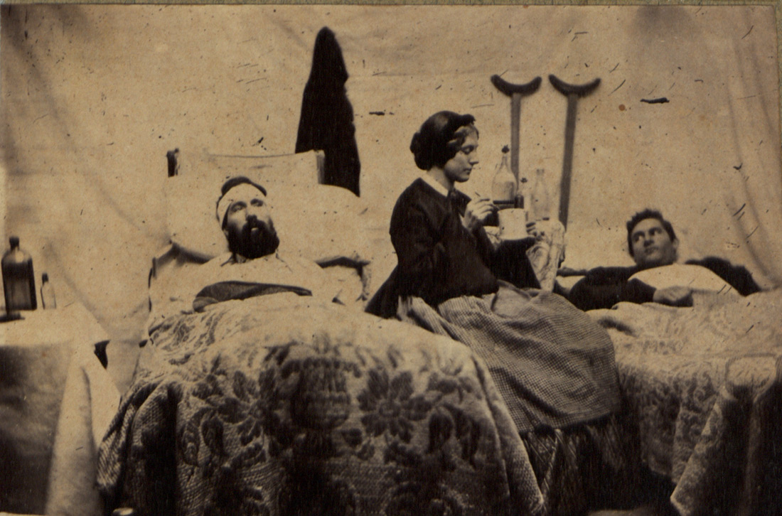 A nurse tends to two Union soldiers in a military hospital in Nashville, Tennessee in 1864. (U.S. Army Heritage and Education Center)