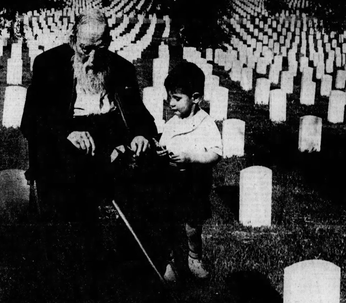 Charles Taggart, a 93-year-old Civil War Veteran, talks to a young boy about his service on Memorial Day in 1936. 