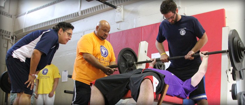 Three veterans lifting weights in a gym