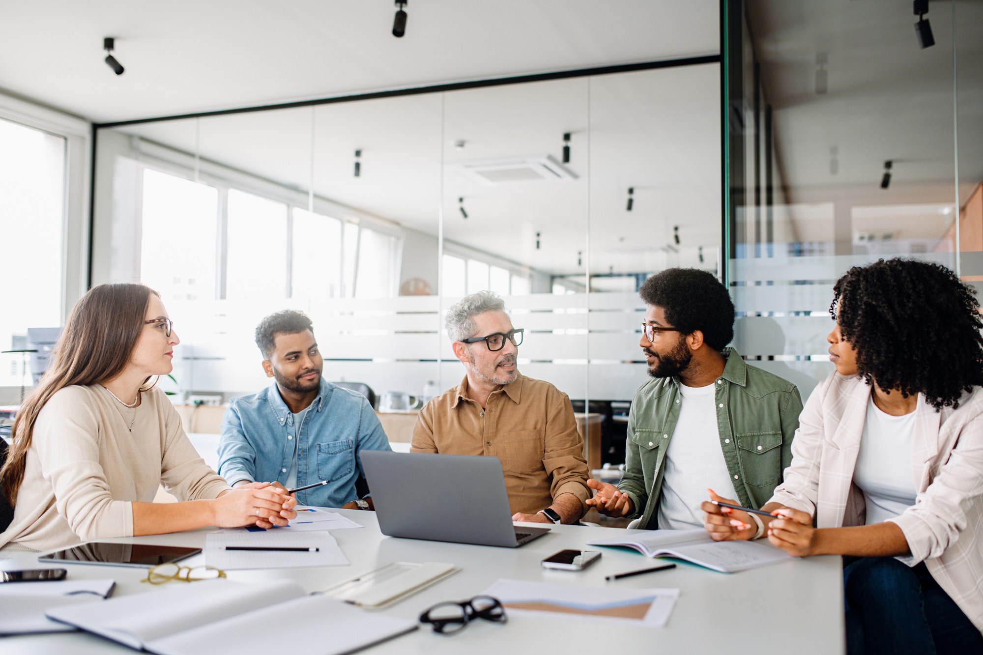 A team of 5 individuals engaged in a strategic meeting.