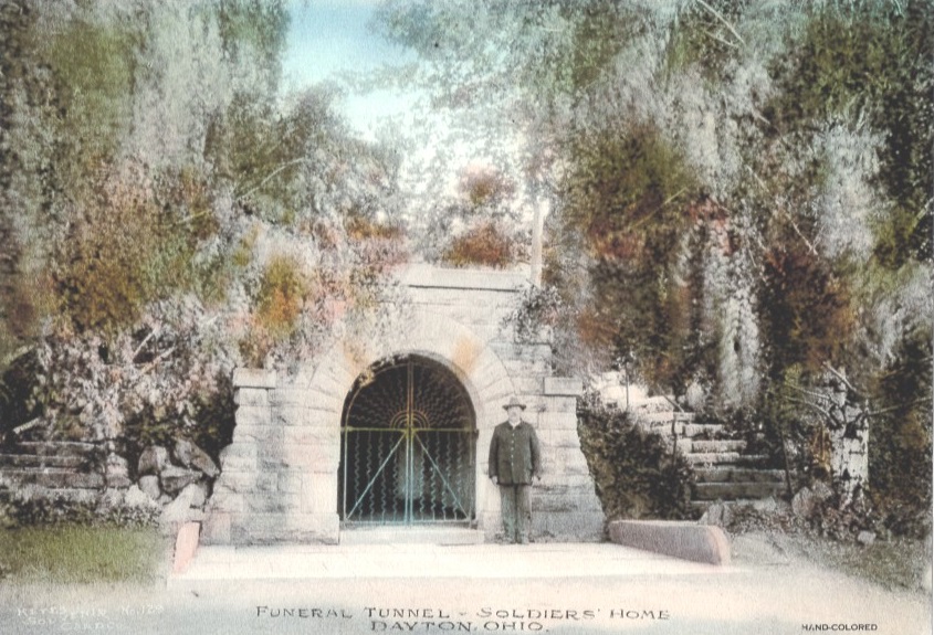 Postcard showing the gated entrance to the 300-foot-long tunnel at the Central Branch of the National Home for Disabled Volunteer Soldiers in Dayton, Ohio. From the hospital morgue, deceased residents were placed in a casket and transported through the tunnel to the cemetery grounds for a funeral service at the church and then burial. (Dayton National Cemetery Support Committee)